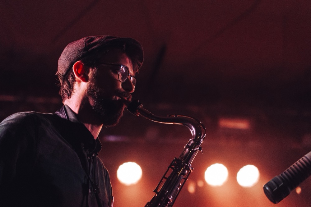Warre on tenor saxophone, warm stage light